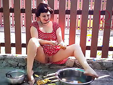 Retro maid prepares potatoes for dinner. Vintage performance. Full video